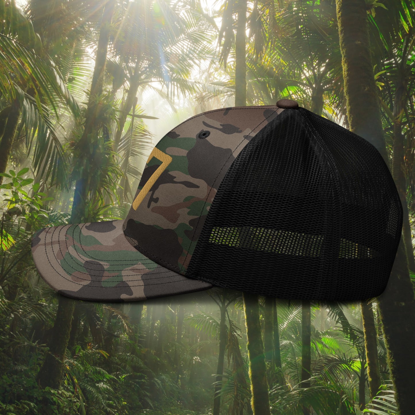 Camouflage cap with black mesh back on a tropical forest background